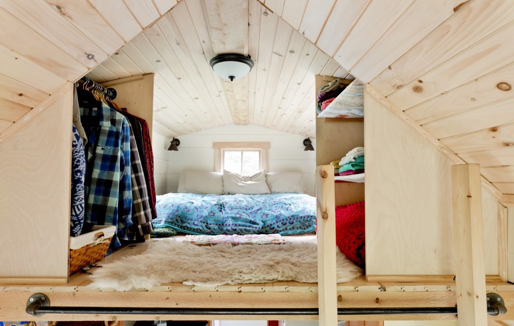 The bedroom is in a loft reached by a ladder. 